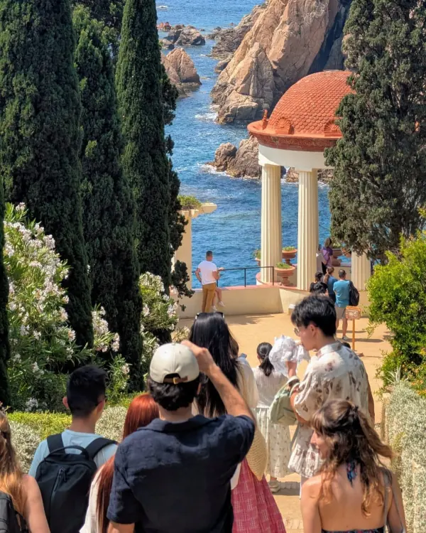 A clifftop garden above the sea, visitors looking out