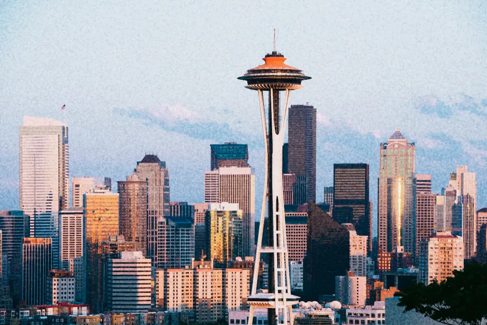 The Seattle skyline at dusk, the Space Needle standing in front of it